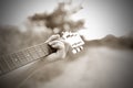 Close-up male hand playing on acoustic guitar outdoor. Vintage tone Royalty Free Stock Photo