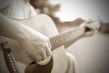 Close-up male hand playing on acoustic guitar outdoor. Vintage tone Royalty Free Stock Photo