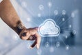 Close up of male hand pointing at digital white cloud hologram with various icons on blurry office interior background. Cloud Royalty Free Stock Photo