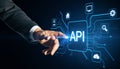 Close up of male hand pointing at glowing api data hologram