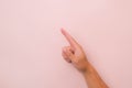 Close-up of male hand pointing  on pink background. Man's hand touching or pointing to something Royalty Free Stock Photo