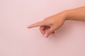 Close-up of male hand pointing  on pink background. Man's hand touching or pointing to something Royalty Free Stock Photo