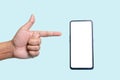 A close-up of the male hand shows a thumbs up smartphone with a white screen and a blue background Royalty Free Stock Photo