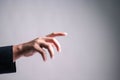 Close-up of a male hand in a suit reaching out or pointing forward,  on gradient background. Great for concepts like touch Royalty Free Stock Photo