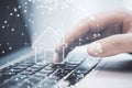 Close up of male hand using laptop keyboard with polygonal sphere with house hologram on blurry background. Digital home concept.