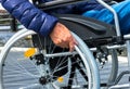 Close-up of male hand on wheel of wheelchair