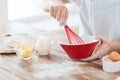 Close up of male hand whisking something in a bowl Royalty Free Stock Photo