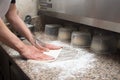 Close-up of male hands baker kneads raw pizza dough. Fast food. Pizza delivery