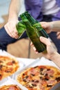 Close up of male hands with beer and pizza at home Royalty Free Stock Photo