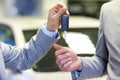 Close up of male hands with car key in auto salon Royalty Free Stock Photo