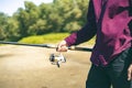 Close up male hands catching fish with spinning on the river bank f Royalty Free Stock Photo