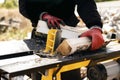 Close up of male hands chopping birch firewood on a hydraulic wood splitter. Sawmill. Birch firewood for fireplac Royalty Free Stock Photo