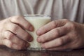 Close-up of male hands with full glass of kefir