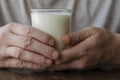 Close-up of male hands with full glass of kefir