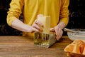 Close up of male hands grating cheese on wooden table Royalty Free Stock Photo