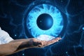 Close up of male hands holding abstract digital blue eye iris on tech background. Technology and vision concept Royalty Free Stock Photo