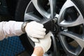 Close-up male hands holding air gun for car wheel Royalty Free Stock Photo