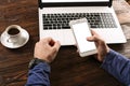 Casually dressed student / blogger / writer / man working on pc laptop, typing on keyboard, writing blog article, drinking in coff Royalty Free Stock Photo