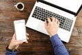 Casually dressed student / blogger / writer / man working on pc laptop, typing on keyboard, writing blog article, drinking in coff Royalty Free Stock Photo