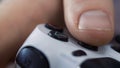 Close up of male hands holding a joystick controller while playing a video games at home - Young man having fun with Royalty Free Stock Photo