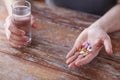 Close up of male hands holding pills and water Royalty Free Stock Photo