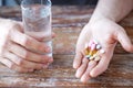 Close up of male hands holding pills and water Royalty Free Stock Photo