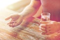 Close up of male hands holding pills and water Royalty Free Stock Photo