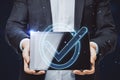 Close up of male hands holding tablet with glowing blue polygonal checkmark on dark blurry background. Success, business agreement Royalty Free Stock Photo