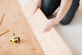 Close up of male hands intalling wood flooring Royalty Free Stock Photo