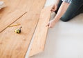 Close up of male hands intalling wood flooring Royalty Free Stock Photo