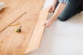 Close up of male hands intalling wood flooring Royalty Free Stock Photo