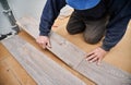 Male worker installing laminate flooring in apartment. Royalty Free Stock Photo