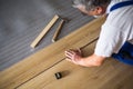 Close up of male hands lying parquet floor board/laminate flooring Royalty Free Stock Photo