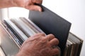 Close-up of male hands, man choosing vinyl records, antiques, old furniture, tables, used things, clothes and other goods are sold Royalty Free Stock Photo