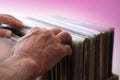 close-up of male hands, man choosing vinyl records, antiques, old furniture, tables, used things, clothes and other goods are sold Royalty Free Stock Photo