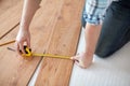 Close up of male hands measuring flooring Royalty Free Stock Photo