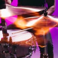 Close-up male hands playing the drums isolated on blue-pink background in neon