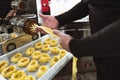 Close up male hands preparing fresh fettucine using machine in pasta factory