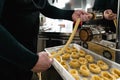 Close up male hands preparing fresh fettucine using machine in pasta factory