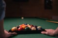 Close up of male hands putting billiard balls on pool table. Playing American pool billiard concept Royalty Free Stock Photo
