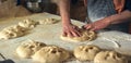 Close up male hands rolling out dough to make traditional ramadan bread