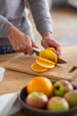 Close-up of male hands slicing juicy orange Royalty Free Stock Photo