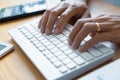 Close-up of male hands typing on keyboard Working On Compute Sitting Table And Office Tools At Workplace, writing emails,