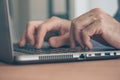 Close up of male hands typing laptop computer keyboard Royalty Free Stock Photo