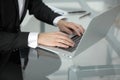 Close-up of male hands typing on notebook compute