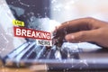 Close up of male hands using laptop with creative polygonal hi-tech breaking news hologram on blurry background. Television,
