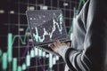 Close up of male hands using laptop with forex candlestick chart on blurry background. Global economic recession, stock market Royalty Free Stock Photo