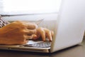 Close up of male hands using Laptop and holding credit card on the desk. Royalty Free Stock Photo