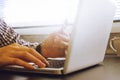 Close up of male hands using Laptop and holding credit card on the desk. Royalty Free Stock Photo