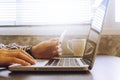 Close up of male hands using Laptop and holding credit card on the desk. Royalty Free Stock Photo